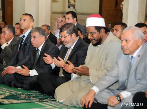 Egyptian President Mohamed Morsi performing Friday noon prayers at a mosque in the district of Fayoum, south west of Cairo, during the Muslim holy fasting month of Ramadan, on July 27, 2012. Photo by Egyptian Presidency