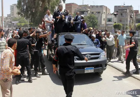 Egypt's President Mohamed Mursi (not pictured) gather outside a mosque where Mursi will be taking part in Friday prayers during the Islamic holy month of Ramadan in Fayoum, about 100 km (60 miles) southeast of Cairo, Jul...
