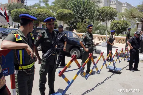 Egyptian policemen stand guard outside a mosque where Mursi will be taking part in Friday prayers during the Islamic holy month of Ramadan in Fayoum, about 100 km (60 miles) southeast of Cairo, July 27, 2012. Photo by Am...