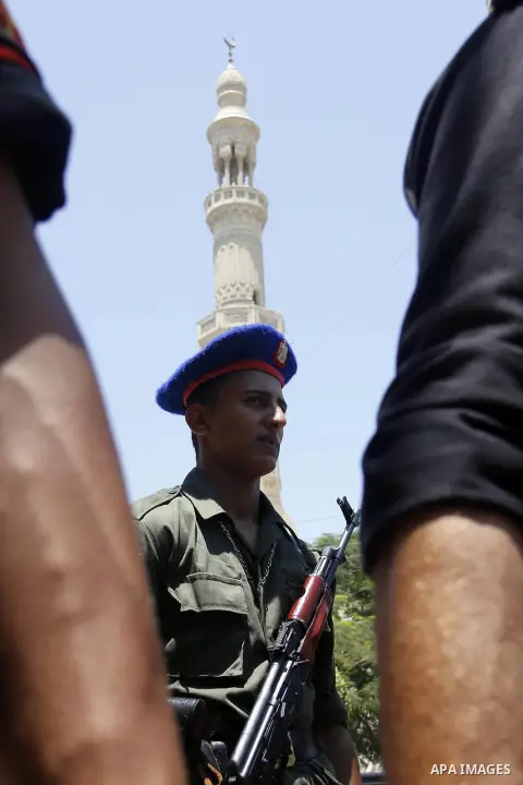 Egyptian policemen stand guard outside a mosque where Mursi will be taking part in Friday prayers during the Islamic holy month of Ramadan in Fayoum, about 100 km (60 miles) southeast of Cairo, July 27, 2012. Photo by Am...