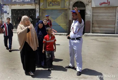 Egypt's President Mohamed Mursi (not pictured) gather outside a mosque where Mursi will be taking part in Friday prayers during the Islamic holy month of Ramadan in Fayoum, about 100 km (60 miles) southeast of Cairo, Jul...