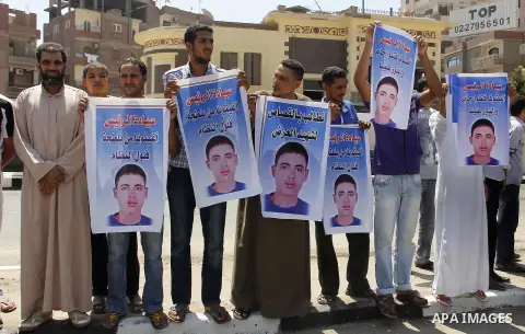 Egypt's President Mohamed Mursi (not pictured) gather outside a mosque where Mursi will be taking part in Friday prayers during the Islamic holy month of Ramadan in Fayoum, about 100 km (60 miles) southeast of Cairo, Jul...