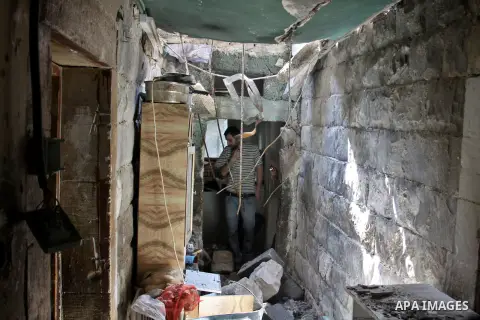 A Palestinian man inspects damage in house for member Islamic Jihad, Abdullah Al Kharouf in the West Bank city of Nablus on 28 July 2012. Photo by Nedal Eshtayah