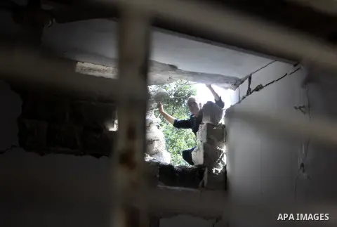 A Palestinian man inspects damage in house for member Islamic Jihad, Abdullah Al Kharouf in the West Bank city of Nablus on 28 July 2012. Photo by Nedal Eshtayah
