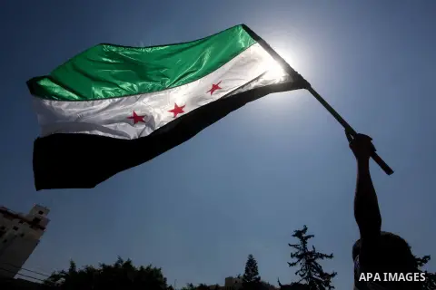 Palestinian children hold a Syrian revolution flag during a protest against Syria's President Bashar al-Assad and support of Syrian Children at the Al joundi Al Majhoul in Gaza City on July 28, 2012. Photo by Ashraf Amra