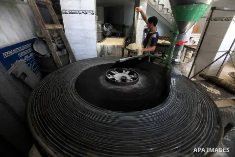 A Palestinian youth makes Konafa in Gaza city on 28 July 2012. Palestinians gets ready for break their fast "Eftar" after long hours of fasting. Bakers make Konafa and traditional pastry known as ''Qatayef'' which is con...