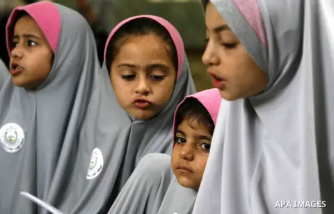 Palestinian girls read the holy Qur'an at mosque in Rafah in southern Gaza strip, on 29 July 2012. Muslims around the world refrain from eating, drinking and sexual intercourse from dawn till dusk during Ramadan, the hol...