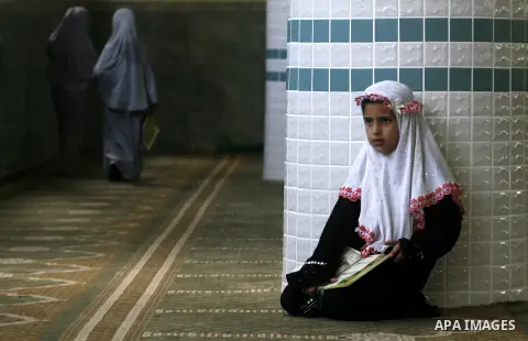 Palestinian girls read the holy Qur'an at mosque in Rafah in southern Gaza strip, on 29 July 2012. Muslims around the world refrain from eating, drinking and sexual intercourse from dawn till dusk during Ramadan, the hol...