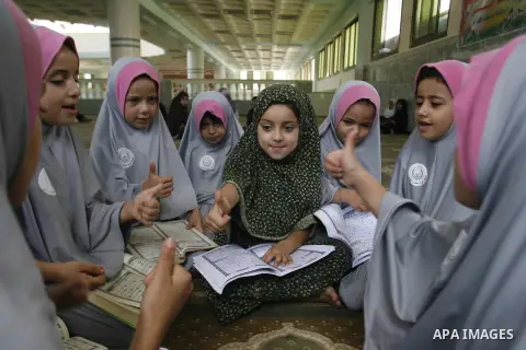 Palestinian girls read the holy Qur'an at mosque in Rafah in southern Gaza strip, on 29 July 2012. Muslims around the world refrain from eating, drinking and sexual intercourse from dawn till dusk during Ramadan, the hol...
