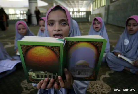 Palestinian girls read the holy Qur'an at mosque in Rafah in southern Gaza strip, on 29 July 2012. Muslims around the world refrain from eating, drinking and sexual intercourse from dawn till dusk during Ramadan, the hol...