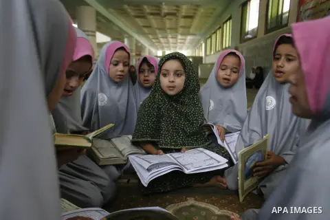 Palestinian girls read the holy Qur'an at mosque in Rafah in southern Gaza strip, on 29 July 2012. Muslims around the world refrain from eating, drinking and sexual intercourse from dawn till dusk during Ramadan, the hol...