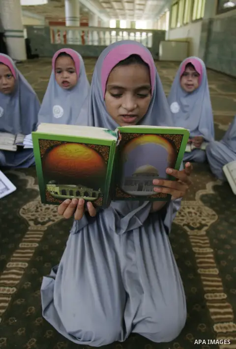 Palestinian girls read the holy Qur'an at mosque in Rafah in southern Gaza strip, on 29 July 2012. Muslims around the world refrain from eating, drinking and sexual intercourse from dawn till dusk during Ramadan, the hol...