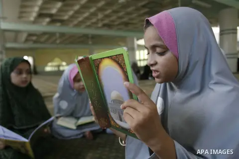 Palestinian girls read the holy Qur'an at mosque in Rafah in southern Gaza strip, on 29 July 2012. Muslims around the world refrain from eating, drinking and sexual intercourse from dawn till dusk during Ramadan, the hol...