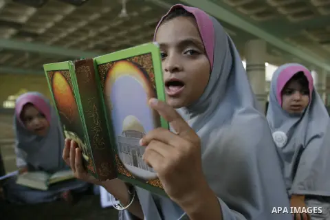 Palestinian girls read the holy Qur'an at mosque in Rafah in southern Gaza strip, on 29 July 2012. Muslims around the world refrain from eating, drinking and sexual intercourse from dawn till dusk during Ramadan, the hol...