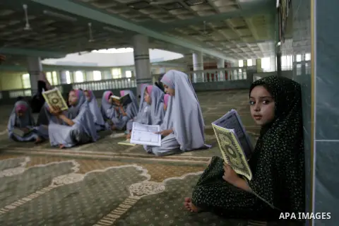 Palestinian girls read the holy Qur'an at mosque in Rafah in southern Gaza strip, on 29 July 2012. Muslims around the world refrain from eating, drinking and sexual intercourse from dawn till dusk during Ramadan, the hol...
