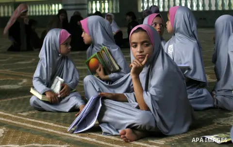 Palestinian girls read the holy Qur'an at mosque in Rafah in southern Gaza strip, on 29 July 2012. Muslims around the world refrain from eating, drinking and sexual intercourse from dawn till dusk during Ramadan, the hol...