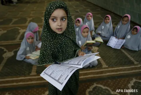Palestinian girls read the holy Qur'an at mosque in Rafah in southern Gaza strip, on 29 July 2012. Muslims around the world refrain from eating, drinking and sexual intercourse from dawn till dusk during Ramadan, the hol...