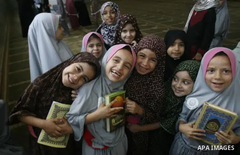 Palestinian girls read the holy Qur'an at mosque in Rafah in southern Gaza strip, on 29 July 2012. Muslims around the world refrain from eating, drinking and sexual intercourse from dawn till dusk during Ramadan, the hol...