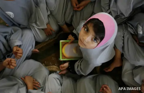 Palestinian girls read the holy Qur'an at mosque in Rafah in southern Gaza strip, on 29 July 2012. Muslims around the world refrain from eating, drinking and sexual intercourse from dawn till dusk during Ramadan, the hol...