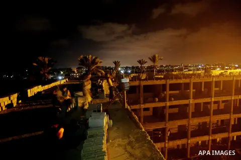 Palestinian construction workers work at night in Deir al-Balah in central Gaza Strip on 29 July 2012. Palestinian construction workers work during the night in the month of Ramadan because of the high temperatures they...