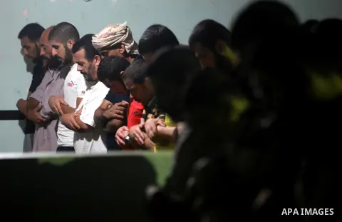 Palestinian inmates participate a prayer during the holy month of Ramadan at prison controlled by the Hamas police in Gaza city on 29 July 2012. Hamas police released more than 150 criminal inmates before the fasting mon...