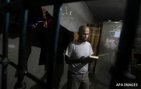 A Palestinian reads holy Qur'an inside his cell during the holy month of Ramadan at prison controlled by the Hamas police in Gaza city on 29 July 2012. Hamas police released more than 150 criminal inmates before the fast...