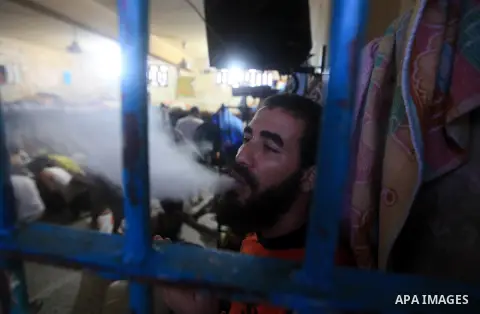 A Palestinian inmate smoke a cigarette inside his cell after breaking his fast during the holy month of Ramadan at prison controlled by the Hamas police in Gaza city on 29 July 2012. Hamas police released more than 150 c...