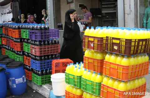 A Palestinian vendor sells bottles of juice in his shop in West Bank city of Nablus on July 30, 2012. Muslims throughout the world are celebrating the fasting month of Ramadan, the holiest month in the Islamic calendar,...