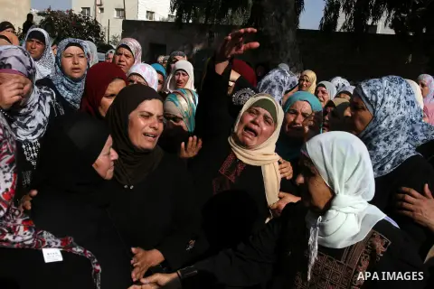 Palestinians women mourn during the funeral of Akram Badr, 46, in the village of Beitillu near in the West Bank city of Ramallah, Tuesday, July 31, 2012. Badr was killed at a checkpoint by the Israeli security forces nea...