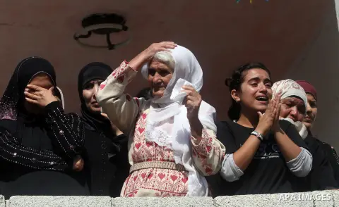 Palestinians women mourn during the funeral of Akram Badr, 46, in the village of Beitillu near in the West Bank city of Ramallah, Tuesday, July 31, 2012. Badr was killed at a checkpoint by the Israeli security forces nea...