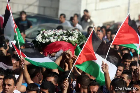 Palestinian mourners carry the body of Akram Badr, 46, during his funeral in the village of Beitillu near in the West Bank city of Ramallah, Tuesday, July 31, 2012. Badr was killed at a checkpoint by the Israeli security...