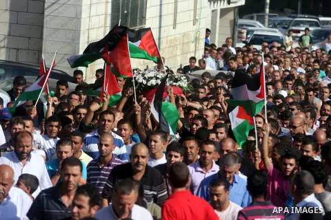Palestinian mourners carry the body of Akram Badr, 46, during his funeral in the village of Beitillu near in the West Bank city of Ramallah, Tuesday, July 31, 2012. Badr was killed at a checkpoint by the Israeli security...