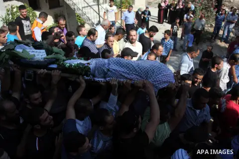Palestinian mourners carry the body of Akram Badr, 46, during his funeral in the village of Beitillu near in the West Bank city of Ramallah, Tuesday, July 31, 2012. Badr was killed at a checkpoint by the Israeli security...