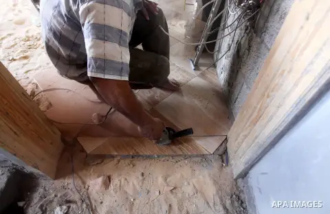 A Palestinian laborer works in flooring during the holy month of Ramadan, in Deir al-Balah in central Gaza Strip on 02 August 2012. During Ramadan, eating, drinking, sex and smoking is banned and restaurants are forbidde...