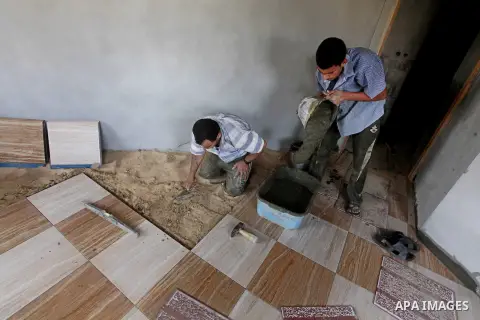 Palestinian laborers work in flooring during the holy month of Ramadan, in Deir al-Balah in central Gaza Strip on 02 August 2012. During Ramadan, eating, drinking, sex and smoking is banned and restaurants are forbidden...