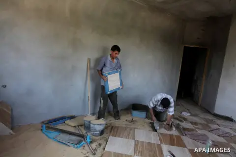 Palestinian laborers work in flooring during the holy month of Ramadan, in Deir al-Balah in central Gaza Strip on 02 August 2012. During Ramadan, eating, drinking, sex and smoking is banned and restaurants are forbidden...