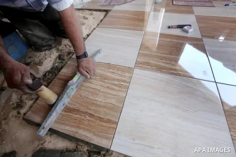 A Palestinian laborer works in flooring during the holy month of Ramadan, in Deir al-Balah in central Gaza Strip on 02 August 2012. During Ramadan, eating, drinking, sex and smoking is banned and restaurants are forbidde...