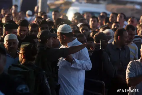 Palestinians wait to cross to Jerusalem from the Qalandia checkpoint near the West Bank city of Ramallah on Aug. 3, 2012. Palestinian Muslims are heading to Jerusalem to attend the third Friday prayers of the fasting mon...