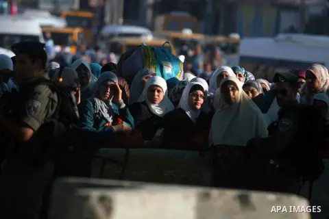 Palestinians wait to cross to Jerusalem from the Qalandia checkpoint near the West Bank city of Ramallah on Aug. 3, 2012. Palestinian Muslims are heading to Jerusalem to attend the third Friday prayers of the fasting mon...