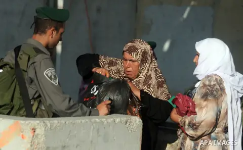 Palestinians cross to Jerusalem from the Qalandia checkpoint near the West Bank city of Ramallah on Aug. 3, 2012. Palestinian Muslims are heading to Jerusalem to attend the third Friday prayers of the fasting month of Ra...
