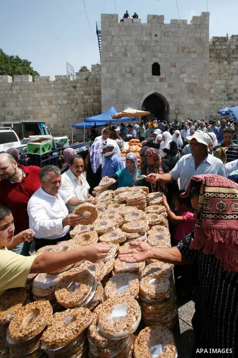 Palestinian Muslims shop outside the al-Aqsa mosque compound in Jerusalem following the third Friday prayers of Islam's holy month of Ramadan on August 3, 2012. Muslims fasting in the month of Ramadan must abstain from f...