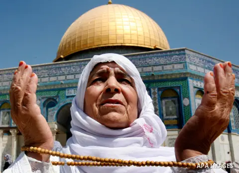 A Palestinian female worshiper prays outside the Dome of the Rock at the al-Aqsa mosque compound in Jerusalem during the third Friday prayers of the Muslim holy month of Ramadan on 03 August 2012. Muslims fasting in the...