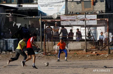 Palestinian youths play football before breaking fast in southern Gaza strip town of Rafah, on 03 August 2012. Muslims fasting in the month of Ramadan must abstain from food, drink and sex from dawn until sunset. Photo b...