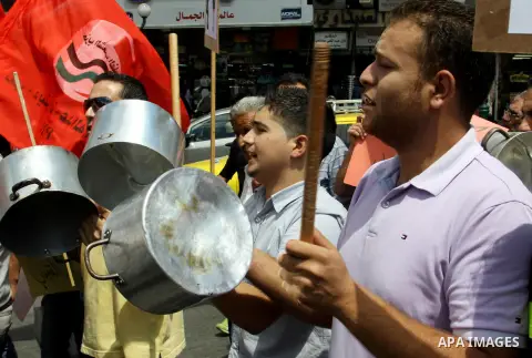 Palestinian demonstrators bang on pots during protest against rising prices and taxes in the West Bank, city of Nablus Aug. 04, 2012. Photo by Nedal Eshtayah