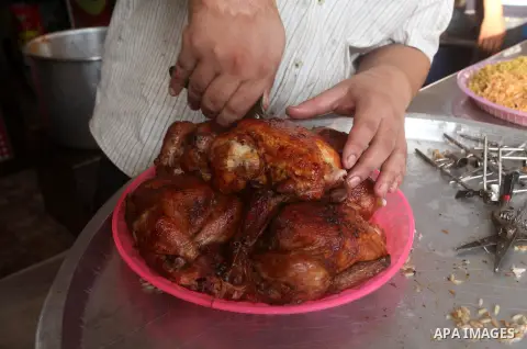 Palestinians prepare chicken as they wait for customers several hours before Iftar, the breaking of the day long Ramadan fast in Gaza City, on Aug. 04, 2012. Muslims around the world refrain from eating, drinking and sex...