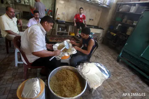 Palestinians prepare rice as they wait for customers several hours before Iftar, the breaking of the day long Ramadan fast in Gaza City, on Aug. 04, 2012. Muslims around the world refrain from eating, drinking and sexual...