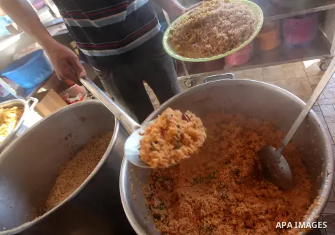 Palestinians prepare rice as they wait for customers several hours before Iftar, the breaking of the day long Ramadan fast in Gaza City, on Aug. 04, 2012. Muslims around the world refrain from eating, drinking and sexual...