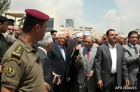 Palestinian President Mahmoud Abbas, accompanied by other officials as he inspects a convoy of trucks carrying food and medical supplies, which reportedly were provided by the Palestinian people, leaving Ramallah bound f...