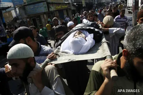 Mourners carry the body of a Palestinian militant Eid Hejazi during his funeral in Rafah, southern Gaza Strip, Sunday, Aug. 5, 2012. Hejazi was killed on an Israeli air strike on Sunday and was a member of the Popular Re...
