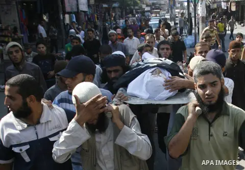 Mourners carry the body of a Palestinian militant Eid Hejazi during his funeral in Rafah, southern Gaza Strip, Sunday, Aug. 5, 2012. Hejazi was killed on an Israeli air strike on Sunday and was a member of the Popular Re...